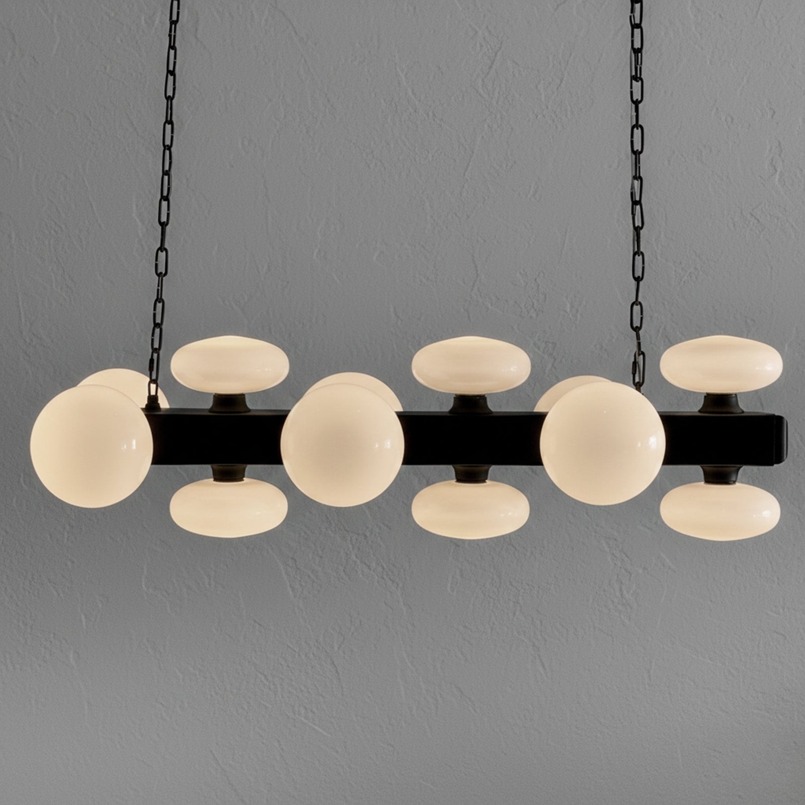 Modern chandelier with spherical glass shades on a gray background