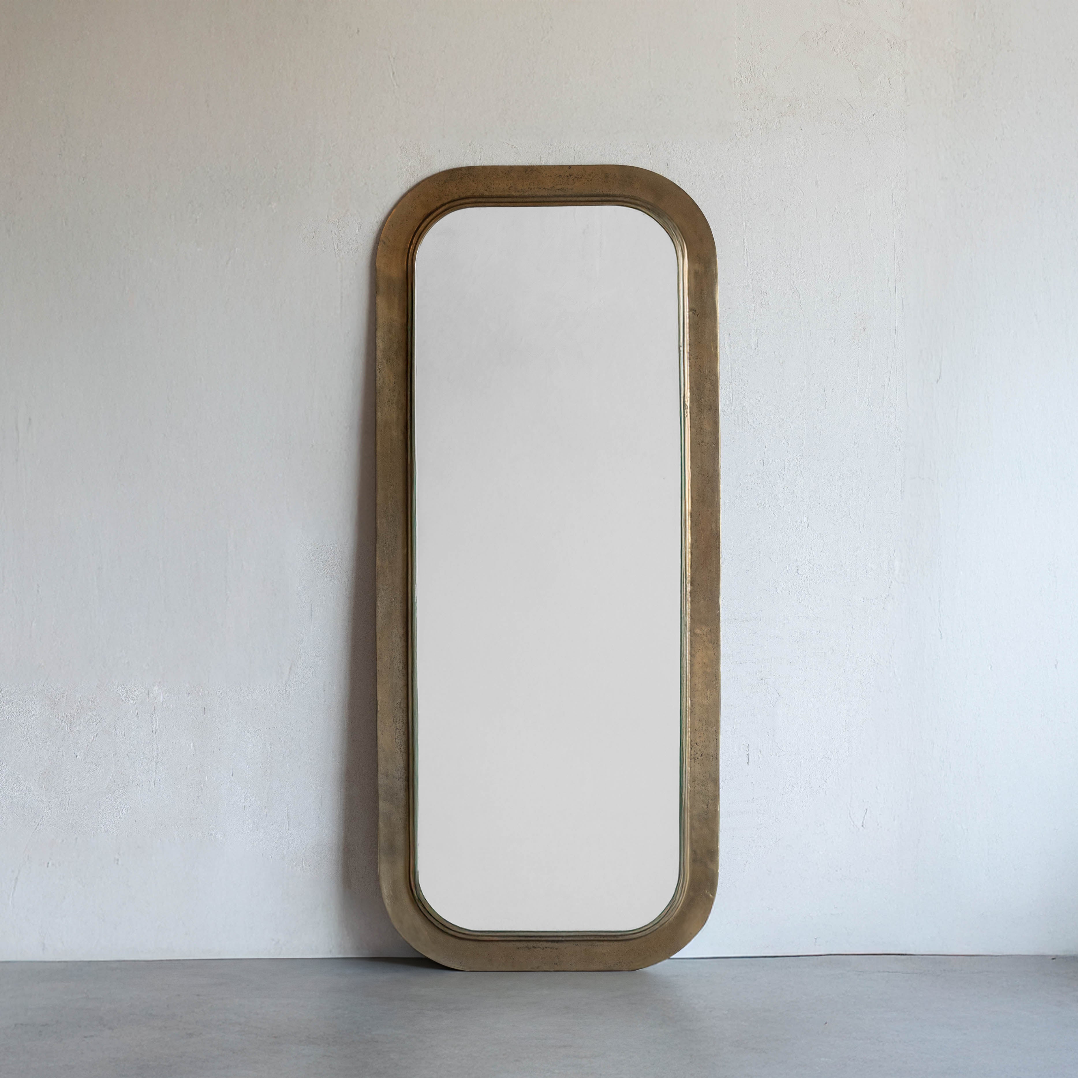 Wooden-framed mirror on a white wall