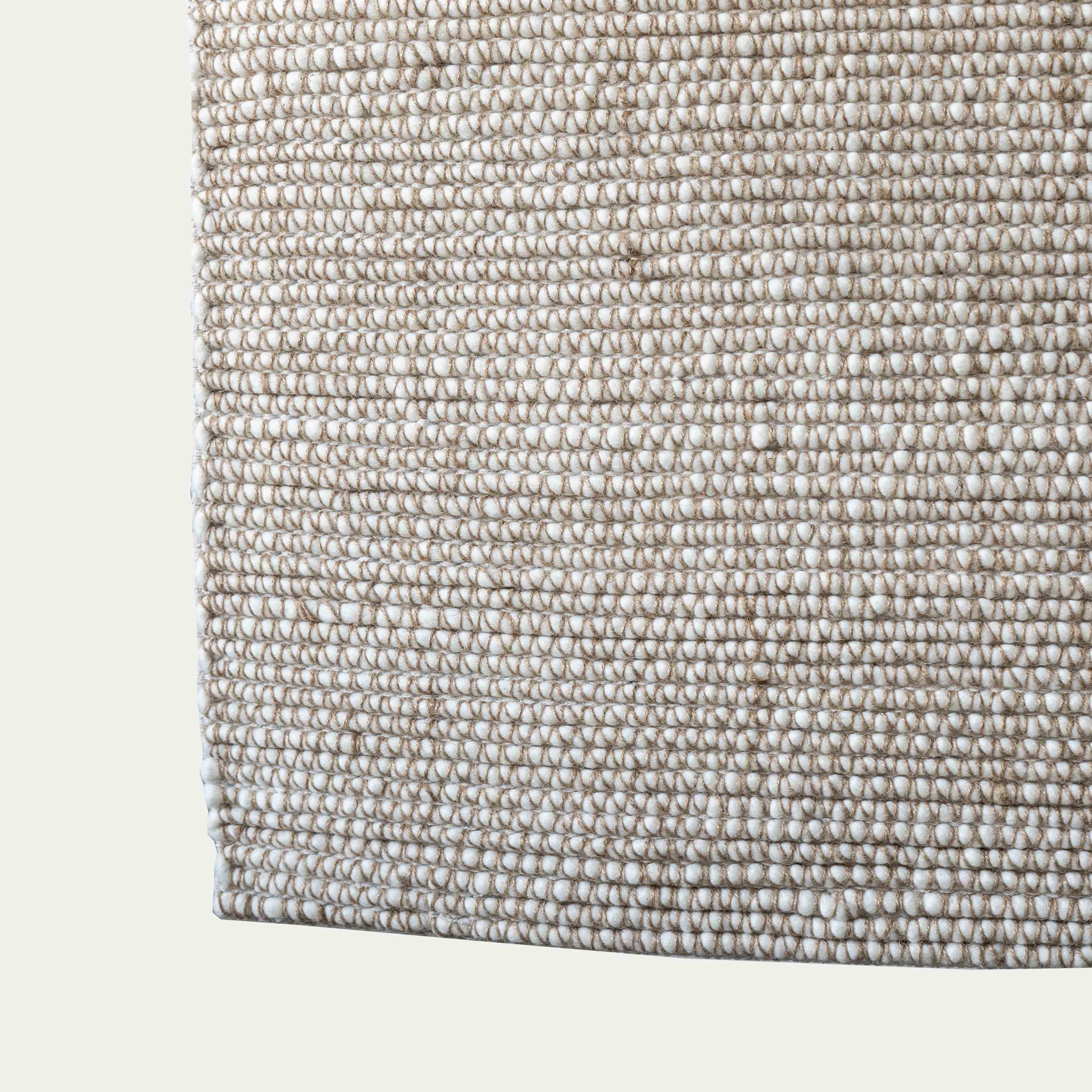 Minimalist ivory and gold rug styled in Dubai home