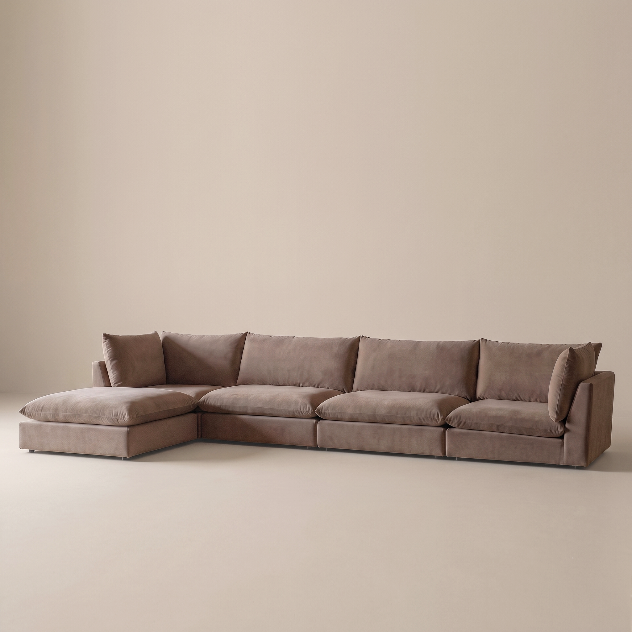 A modern sectional sofa in a taupe-brown fabric, featuring a left-facing chaise lounge and multiple plush back cushions, set against a minimalist beige studio background.