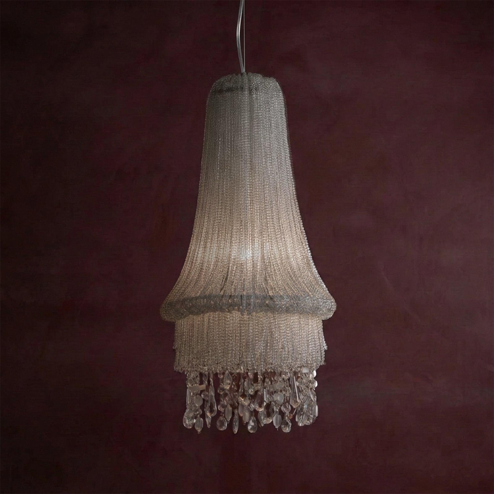 Chandelier with crystal details against a dark red background