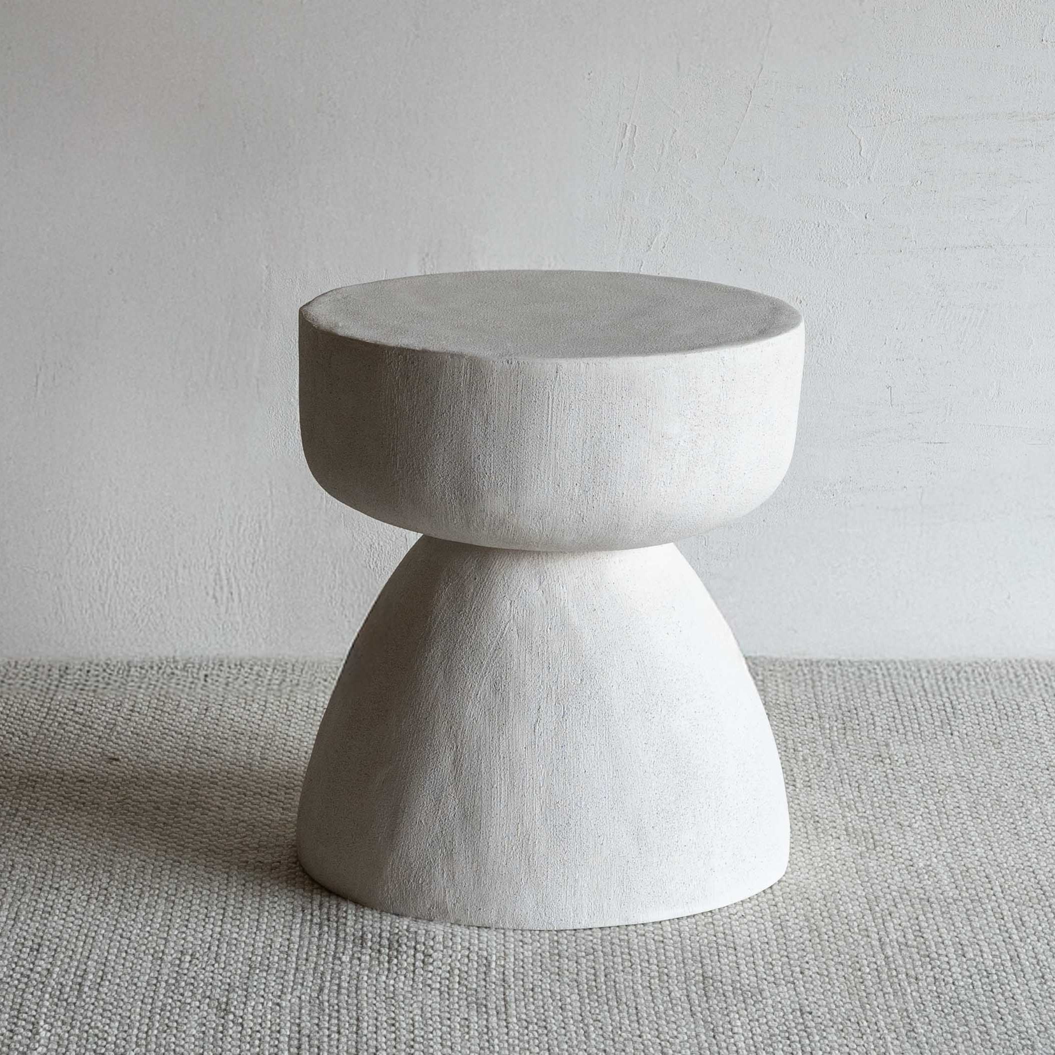 Concrete side table on a neutral background