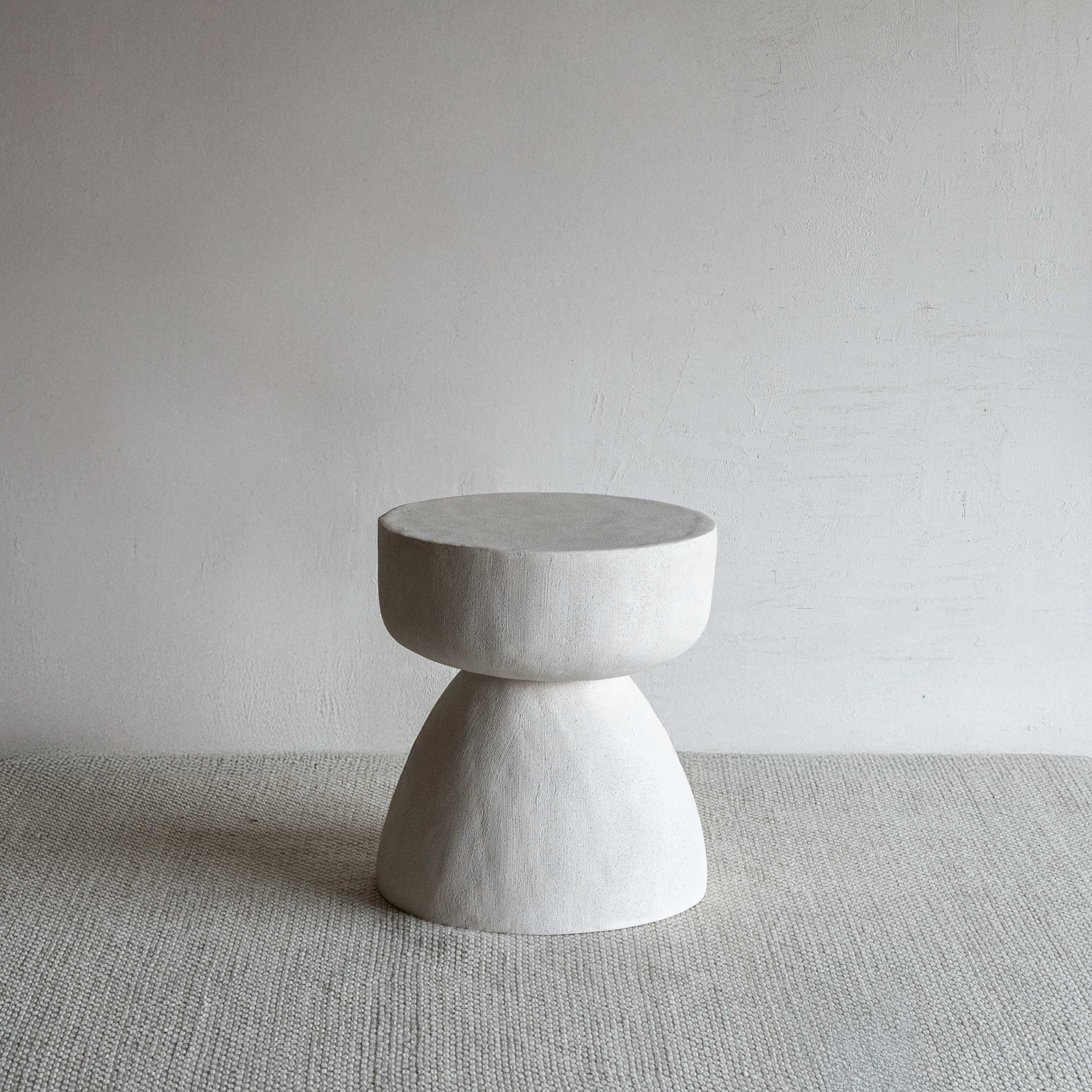 Concrete side table on a neutral background
