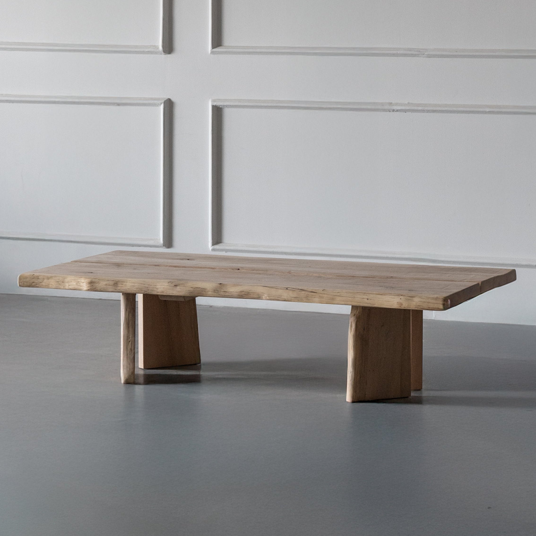 Wooden table against a gray wall with paneling